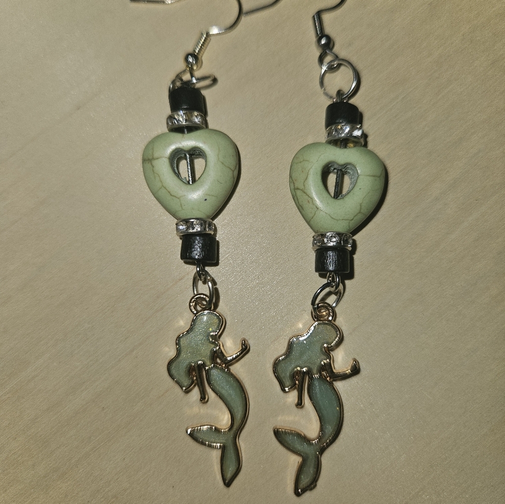 Green stone heart beads with green enamel mermaid charm earrings.